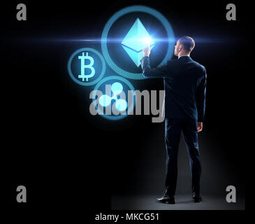 buisnessman with cryptocurrency holograms Stock Photo