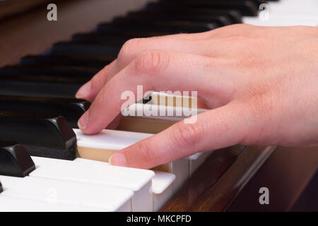 Closeup of a woman's hand playing piano Stock Photo