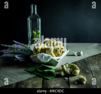 greaves with oil and spices, on a traditional wooden countertop with candle and black background, Stock Photo