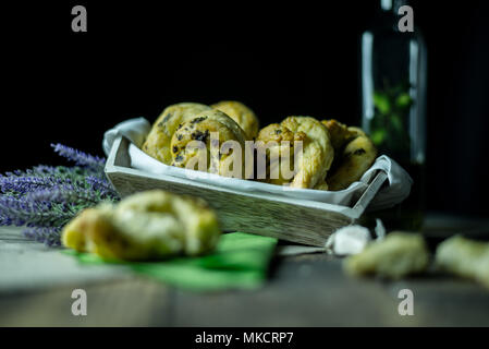 greaves with oil and spices, on a traditional wooden countertop with candle and black background, Stock Photo