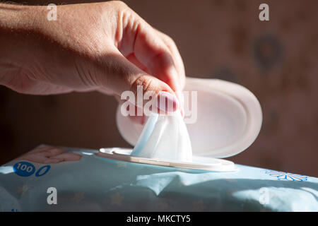 Hand picked a wet wipes in package box, Wet wipes in a woman's hand Stock Photo