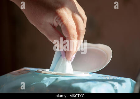 Hand picked a wet wipes in package box, Wet wipes in a woman's hand Stock Photo
