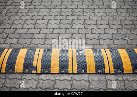 Speed bump on a paved road, selective focus. Stock Photo