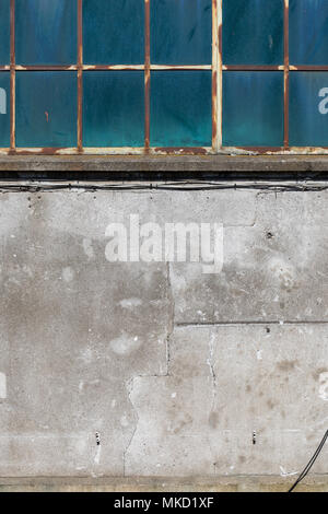 Old industrial building; metal-frame window and concrete wall; Copenhagen Harbour, Denmark Stock Photo