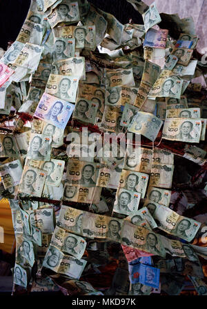 Money - The Thai currency Baht in the prostitutes temple Wat Kanikapon in Chinatown in Bangkok in Thailand in Southeast Asia Far East. Charity Travel Stock Photo