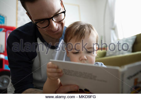 Father reading story book to baby son