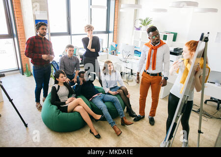 energetic youth is concentrated on listening to the redhaired female coach in the session Stock Photo