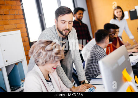 young bearded guy is flirting with female programmer with stylish haircut. close up photo Stock Photo