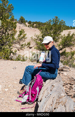 Female middle aged hiker pauses for a drink Stock Photo