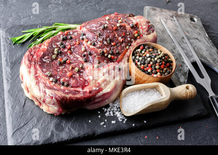 Marbling ribeye steak on black plate Stock Photo