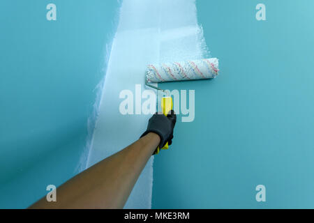 Hand with painting roller Stock Photo