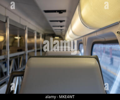 Close up of a train headrest with cargo space in the rear Stock Photo