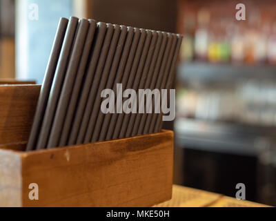 Container filled with paper straws at a bar ready to be used in drinks Stock Photo