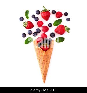 Assorted berry fruit in waffle ice cream cone. Flat lay concept over a white background.