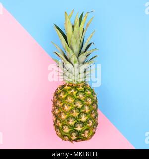 Pineapple on a modern pastel pink and blue angular background. Minimal summer concept. Stock Photo