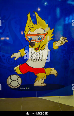 ST. PETERSBURG, RUSSIA, 29 APRIL 2018: Indoor view of the official mascot of the 2018 FIFA World Cup wolf Zabivaka it means small scorer, and kicking the ball in the poster Stock Photo