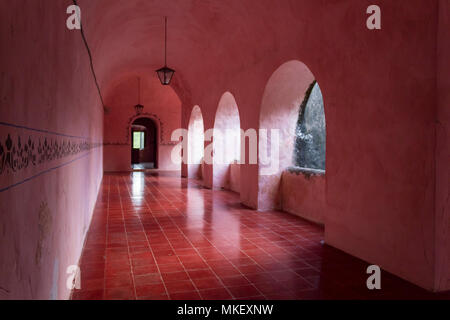 Pink corridors in colonial house. Once a palace for the elite, this is now a museum in Mexico. All corridors and rooms are painted pink Stock Photo