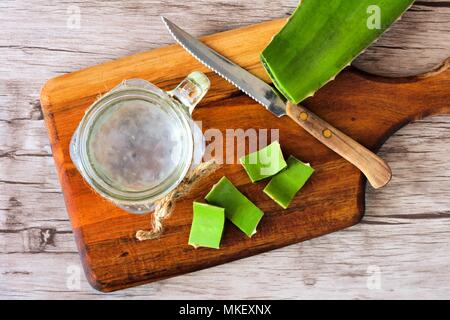 Healthy Aloe vera juice in a mason jar glass. Top view scene on a wooden paddle board. Stock Photo