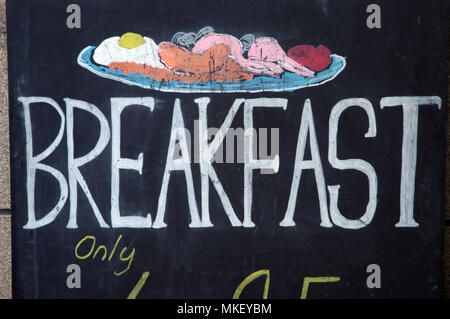 Hand lettering with a sketch of a breakfast in cafe with breakfast sign written on a blackboard with artwork of a breakfast Stock Photo