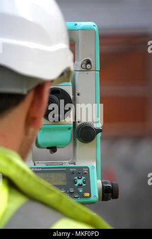land surveying surveyor measures at a construction site Stock Photo