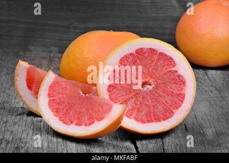Fresh red grapefruit on gray rustic wooden table Stock Photo