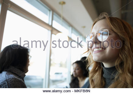Portrait smiling, confident, ambitious young woman looking away