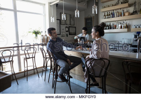Young couple on date, drinking red wine in bar