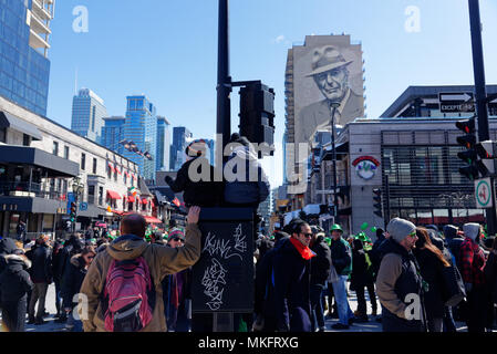 Two children sat up high to watch the St Patrick's Day parade in Montreal Stock Photo