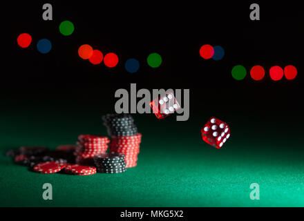 tumbling dice showing various numbers.  Craps, casino chips action and room in frame for copy space Stock Photo