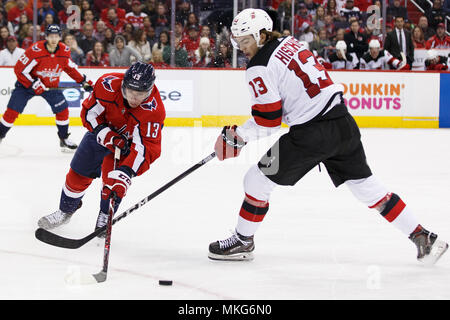 Washington Capitals left wing Jakub Vrana (13) and New Jersey Devils center Nico Hischier (13) compete for a loose puck. Stock Photo