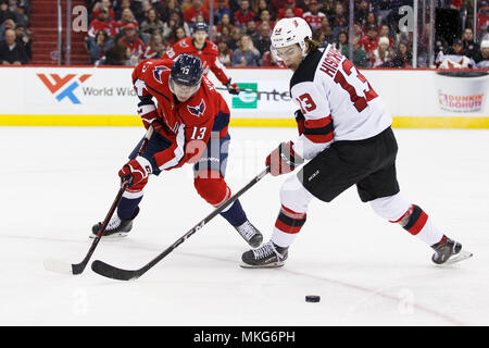 Washington Capitals left wing Jakub Vrana (13) and New Jersey Devils center Nico Hischier (13) compete for a loose puck. Stock Photo