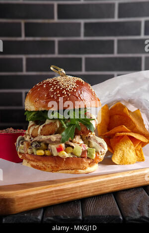 Bacon burger on wooden plate Stock Photo