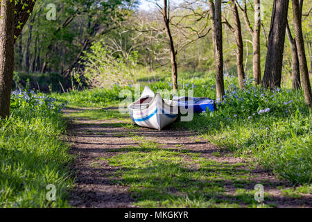 Canoes at rest along the riverside during golden hour in rural Midwest, Illinois, USA. Stock Photo