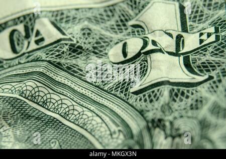 Shallow depth of field close up of the ONE on a wrinkled American dollar bill. Stock Photo