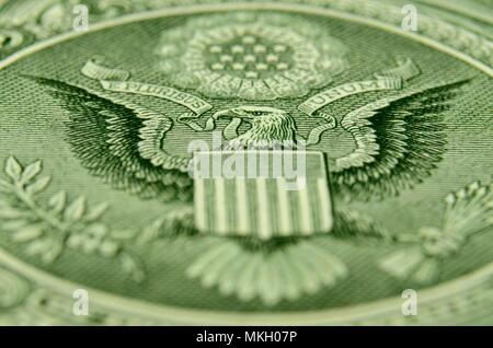 Shallow depth of field shot of American eagle, from the US coat of arms, on the back of the dollar bill. Stock Photo