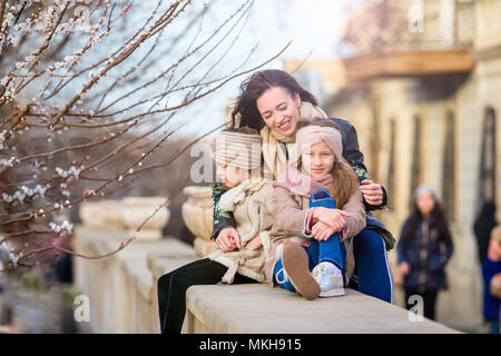 Mother and little daughters outdoor in city Stock Photo