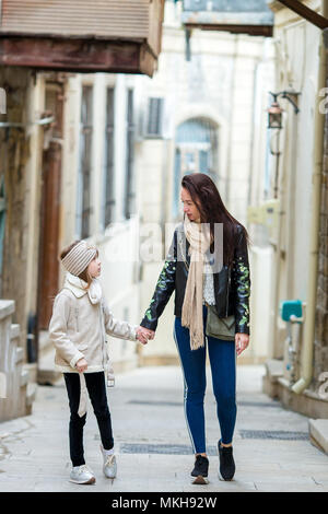 Mother and little daughters outdoor in city Stock Photo