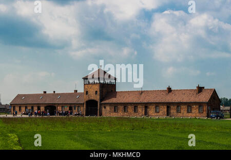 Main entrance to nazi concentration camp of Auschwitz II Birkenau in Oświęcim, Poland. Beautiful view of the gate during a sunny spring day. Stock Photo