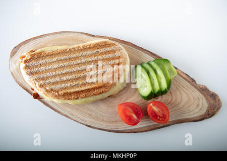 Turkish Sandwich Toast (Tost) with cheddar or melted cheese on wooden background ,top view Stock Photo