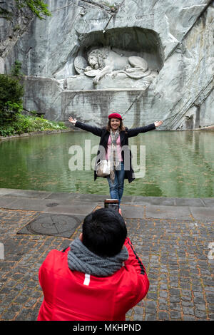 Tourists taking pictures with smartphone in front of the Dying Lion monument in Lucerne, Switzerland, Europe Stock Photo