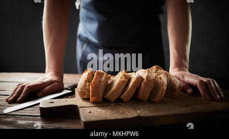 Whole grain bread put on a kitchen plate with a chef, Stock Photo