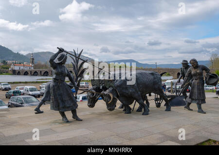 Bronze statues of rural people farming using ancient techniques in Ponte de Lima, Portugal, Europe Stock Photo