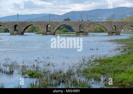 Medieval and roman arched bridge over the Lima river in Ponte de Lima, Portugal, Europe Stock Photo
