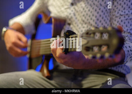 Selective focus photo of a man playing a bodiless guitar Stock Photo
