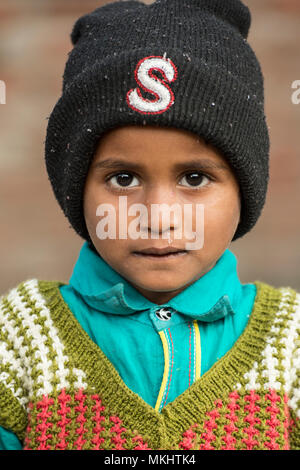 RAJASTHAN - INDIA - 05 JANUARY 2018. Portrait of a young boy with his black hat. Picture taken from a rural village in Rajasthan. India. Stock Photo