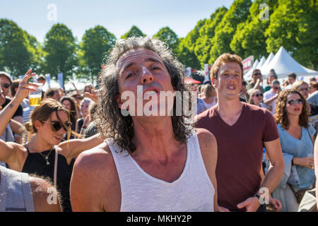 Middle aged man with long hair intensely enjoying music at liberation feast in the Netherlands Stock Photo
