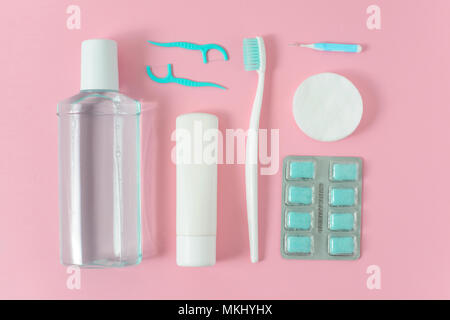 Toothbrushes, toothpaste, rinse and chewing gum set on pink background. Dental and healthcare concept. Stock Photo