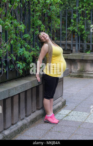 Pregnant Woman Exercise Outdoors Stock Photo