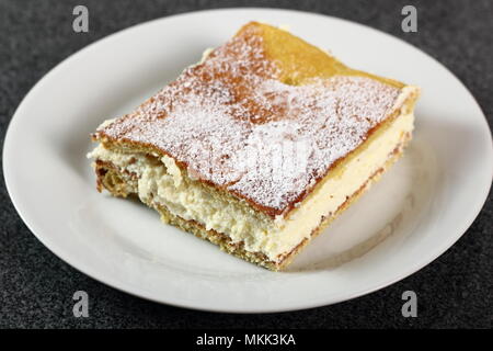 Karpatka. Traditional Polish Cream Pie filled with pudding cream. Stock Photo