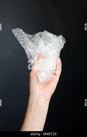Plastic bubble wrap polyethylene package material in hand. Recycling, electricity, environment and ecology concept Stock Photo